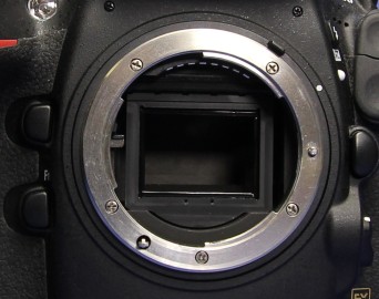 Later Nikon VAF housing with crescent-shaped lower protrusion and rubber retention pads
